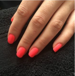 Bright red gel manicure on almond nails